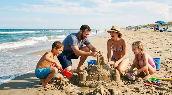 Family playing together on a sandy USA beach vacation